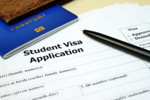 student visa application form with passport and pen