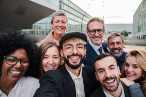 Multicultural business team in a meeting taking a selfie outdoor