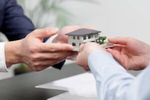 Hands of a businessman selling real estate