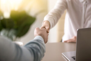 handshake, male and female hands shaking as a symbol of effective negotiations, making agreement